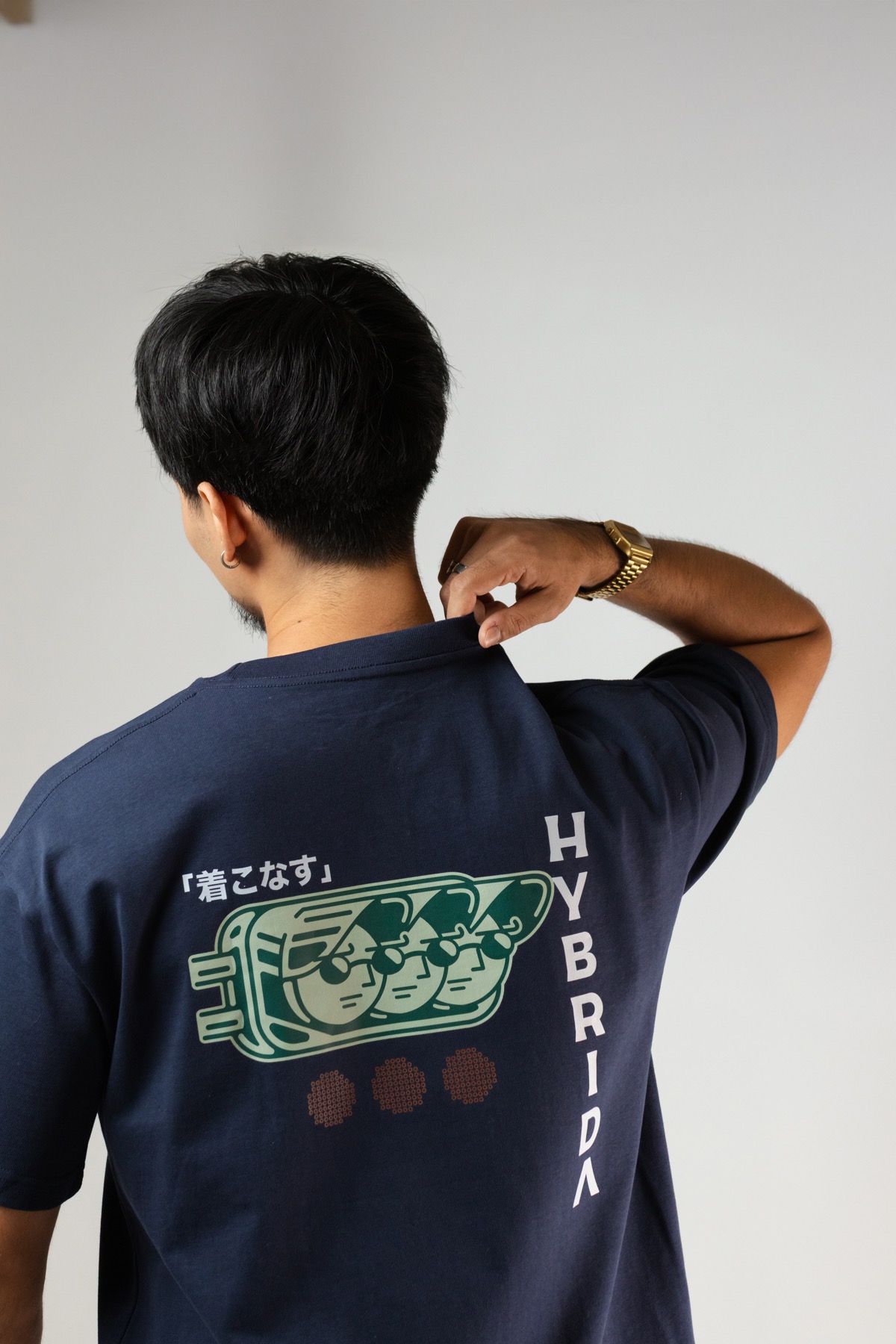 Hybrida 280gsm tee in field shoot — back view showing KIKO graphic and garment drape